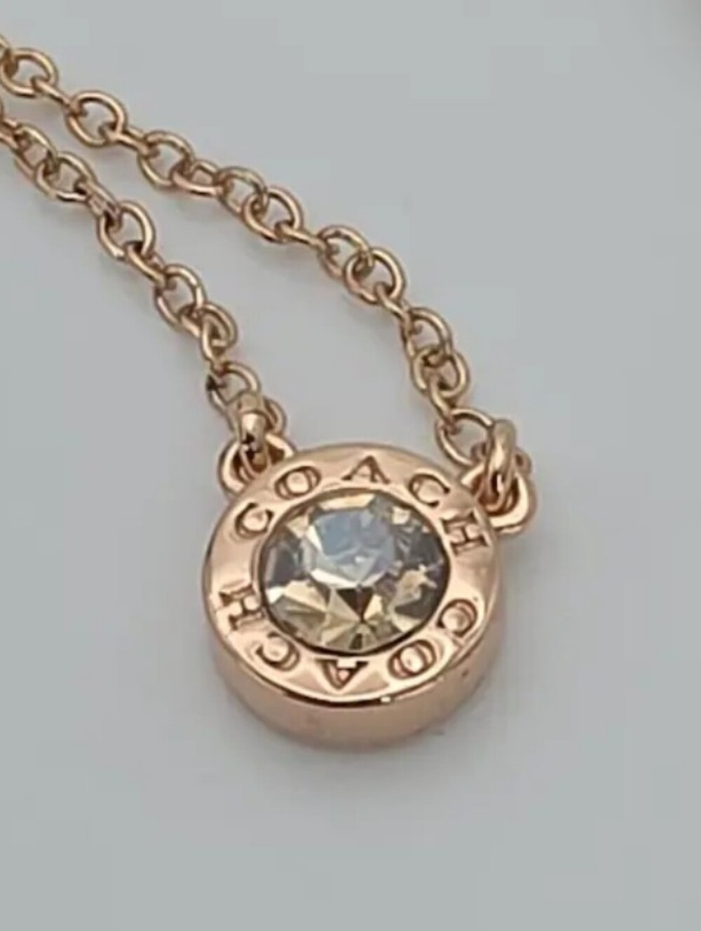 COACH Rose Gold Crystal Logo Disc Necklace